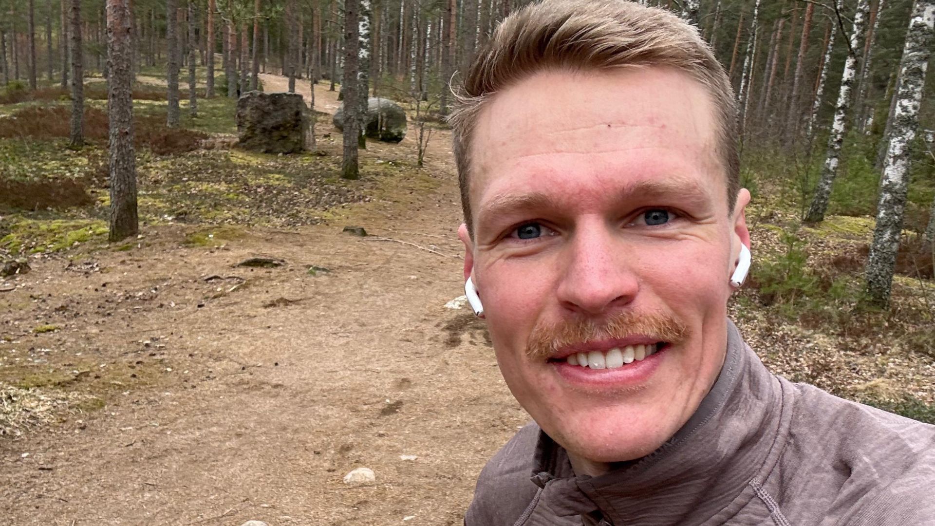 Kuvassa Topi Raitanen lenkkipolulla metsäisessä ympäristössä. 